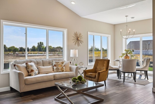 living room featuring a healthy amount of sunlight, a notable chandelier, and dark wood-type flooring