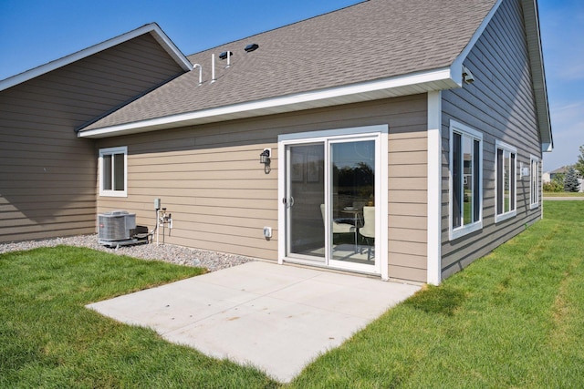 rear view of house with a lawn and a patio