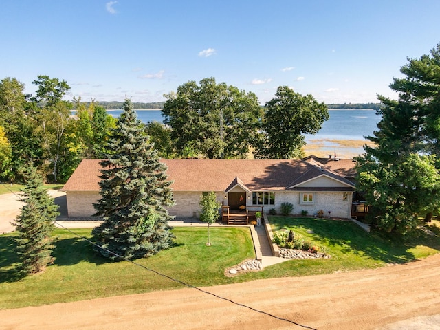 ranch-style home with a water view and a front lawn