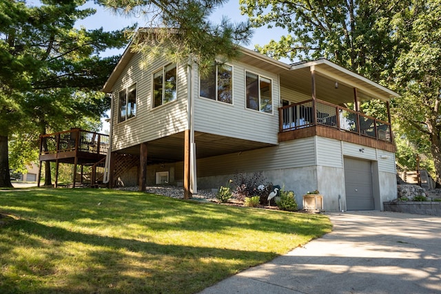 exterior space with a wooden deck, a garage, and a lawn