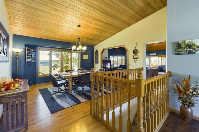 dining room featuring a healthy amount of sunlight, wood-type flooring, and a chandelier