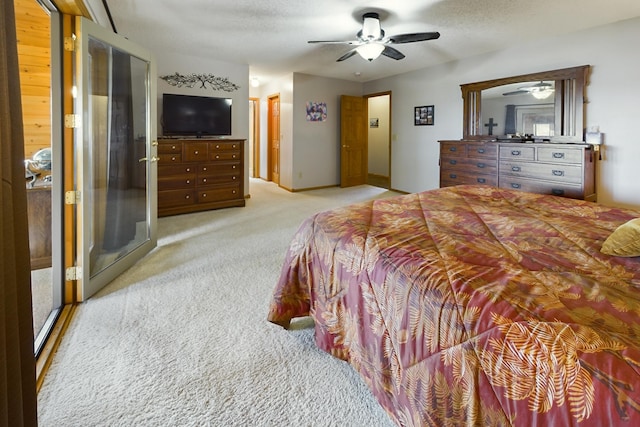 bedroom with ceiling fan, light colored carpet, and a textured ceiling