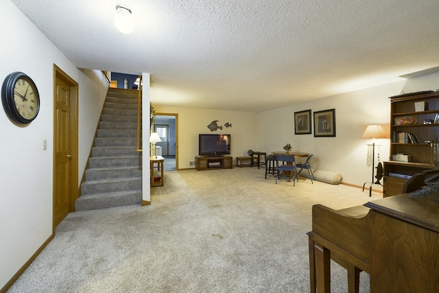 living room with a textured ceiling and carpet