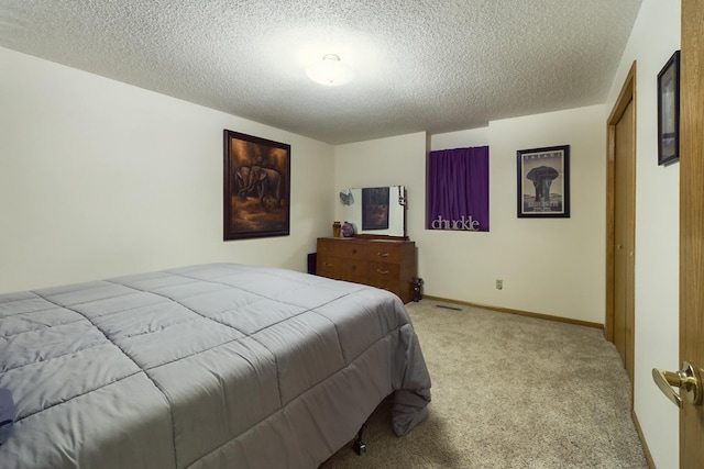 carpeted bedroom featuring a textured ceiling