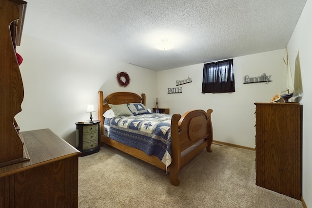 carpeted bedroom with a textured ceiling