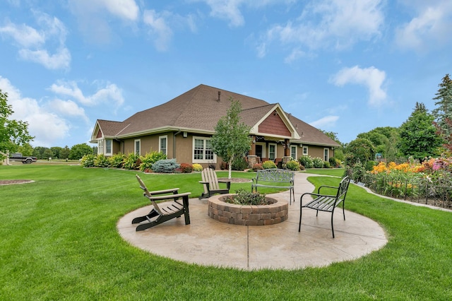 exterior space featuring a lawn, a patio area, and an outdoor fire pit