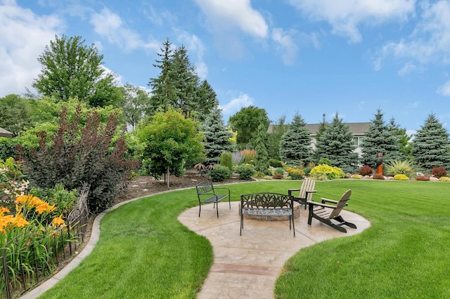 view of community featuring a patio, an outdoor fire pit, and a yard