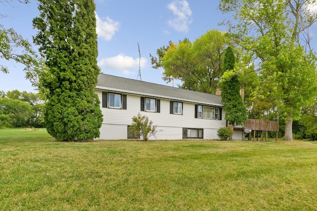 exterior space featuring a front lawn and a wooden deck