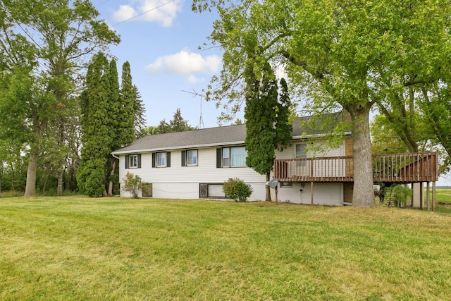 back of property featuring a wooden deck and a yard