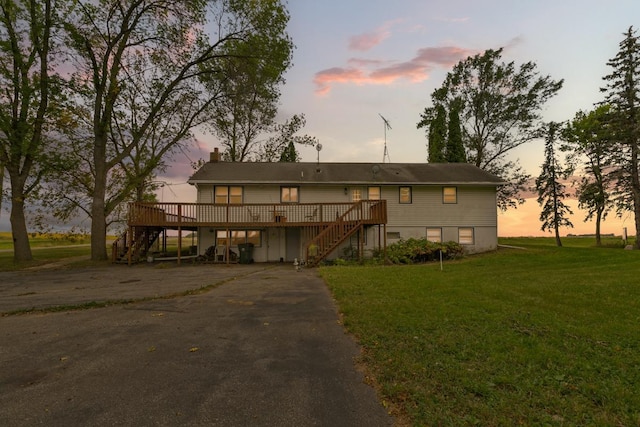 view of front of property with a yard and a wooden deck