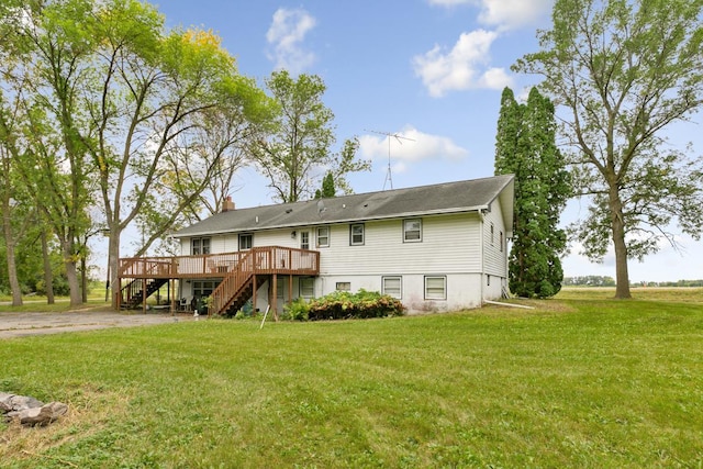 back of house featuring a deck and a lawn