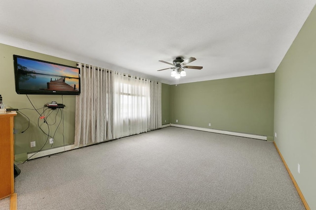 interior space featuring ceiling fan, baseboard heating, and carpet