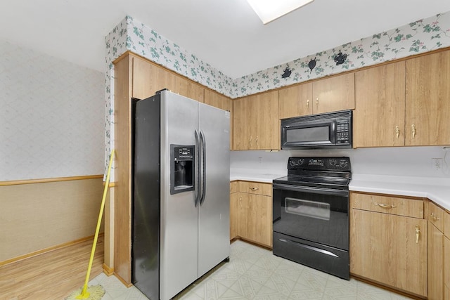 kitchen featuring black appliances and light wood-type flooring