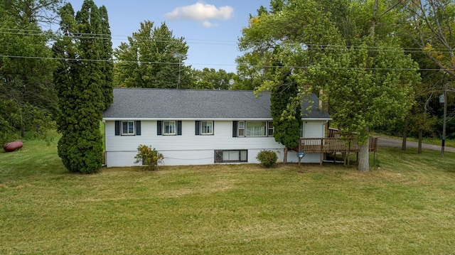 view of front facade featuring a front yard and a wooden deck