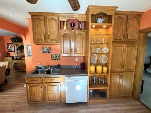 kitchen with white dishwasher, light hardwood / wood-style floors, ceiling fan, and sink