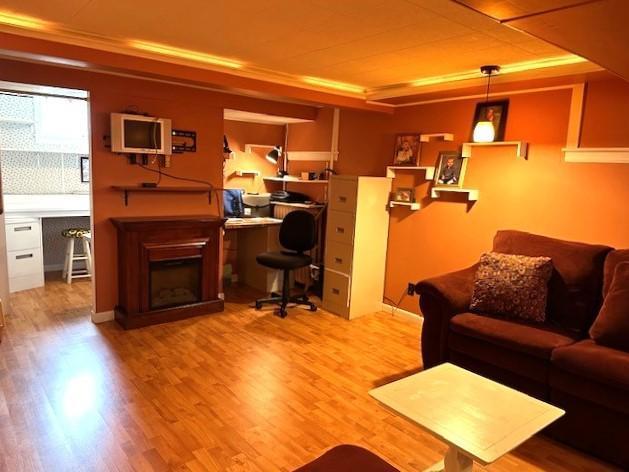 207 6th St, Montevideo, MN 56265 - living room with wood finished floors, a fireplace, and built in desk