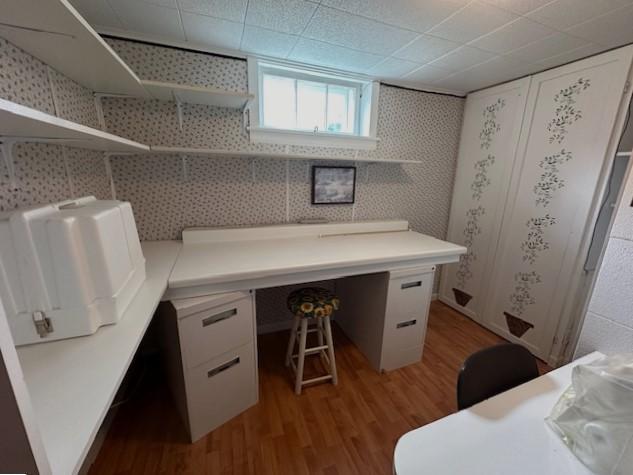 207 6th St, Montevideo, MN 56265 - office space with light wood-type flooring, built in study area, and wallpapered walls