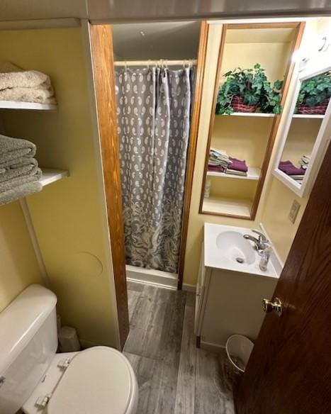 207 6th St, Montevideo, MN 56265 - bathroom with wood finished floors, vanity, and a shower with curtain