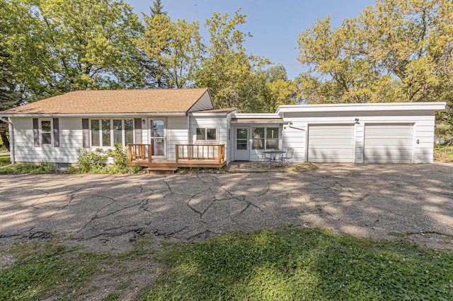 view of front of house featuring a garage and a deck