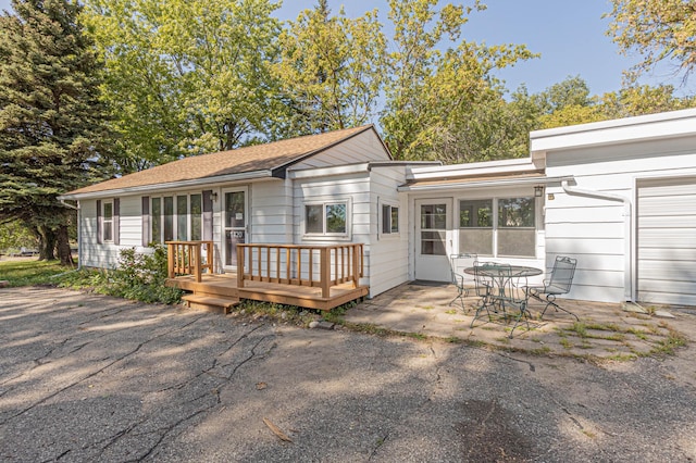 exterior space featuring a garage and a deck