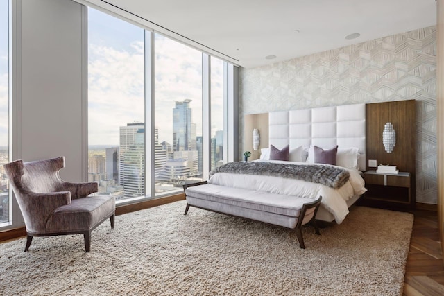 255 Hennepin Ave Unit 3402, Minneapolis, MN 55401 - bedroom featuring a view of city, wallpapered walls, and floor to ceiling windows