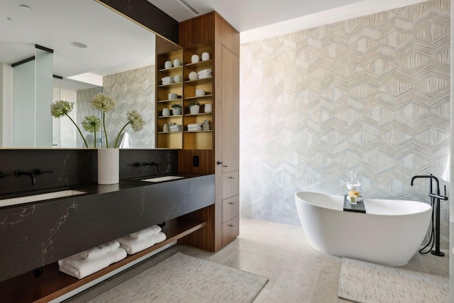 bathroom featuring vanity, a tub to relax in, and tile patterned floors