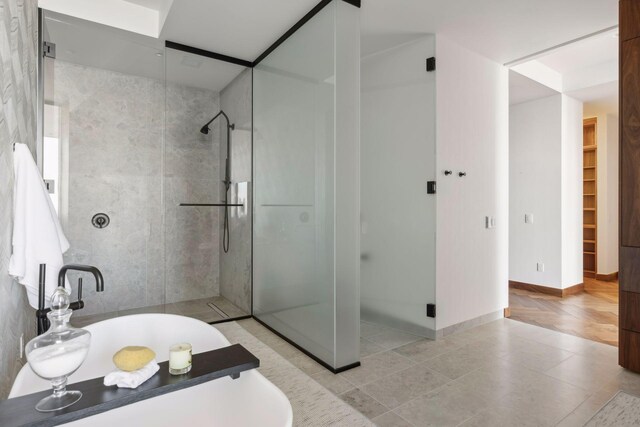 255 Hennepin Ave Unit 3402, Minneapolis, MN 55401 - full bathroom featuring a stall shower, tile patterned flooring, and baseboards