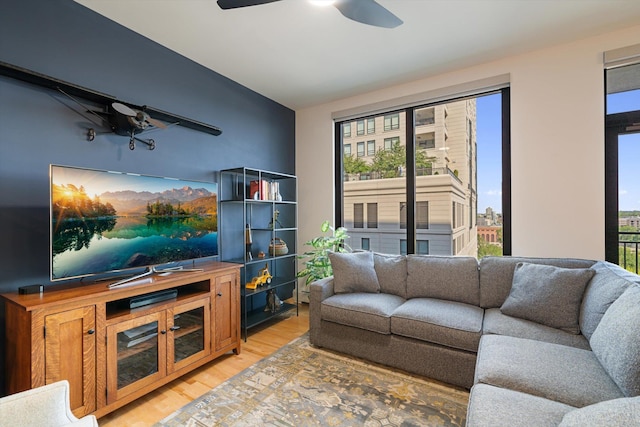 living room with ceiling fan, a wealth of natural light, and wood-type flooring