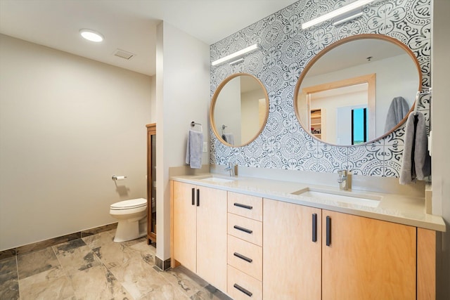 bathroom with toilet and vanity