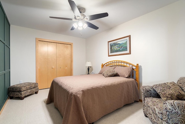 bedroom with light carpet, ceiling fan, and a closet