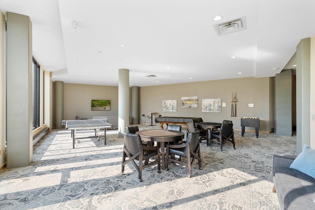 carpeted dining room featuring ornate columns