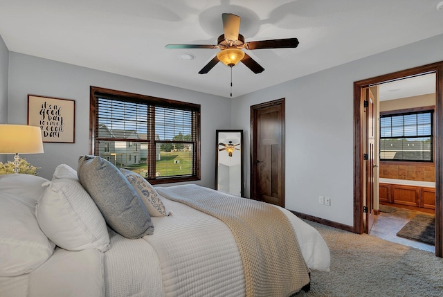 bedroom featuring carpet floors, multiple windows, a ceiling fan, and baseboards