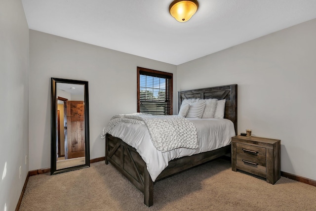 bedroom featuring baseboards and light colored carpet