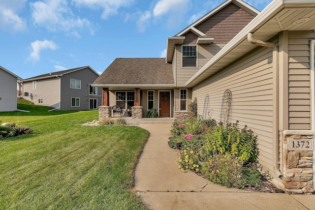 view of front facade with stone siding and a front lawn