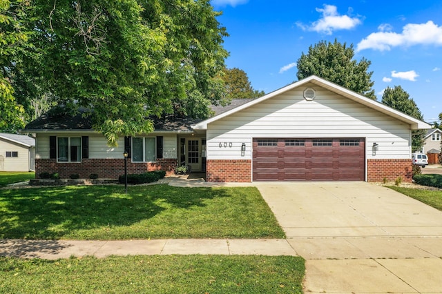 ranch-style house featuring a garage and a front lawn