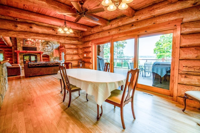 dining room featuring wood ceiling, light hardwood / wood-style floors, beam ceiling, log walls, and ceiling fan with notable chandelier