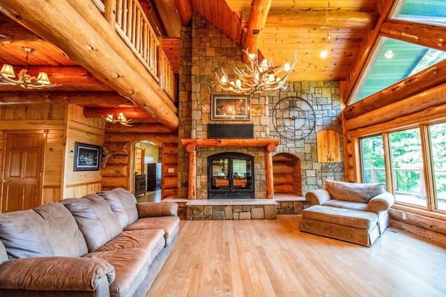 living room with hardwood / wood-style floors, beamed ceiling, a stone fireplace, log walls, and high vaulted ceiling