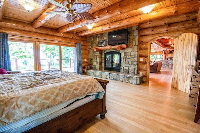 bedroom with log walls, wood ceiling, light hardwood / wood-style floors, ceiling fan, and beam ceiling