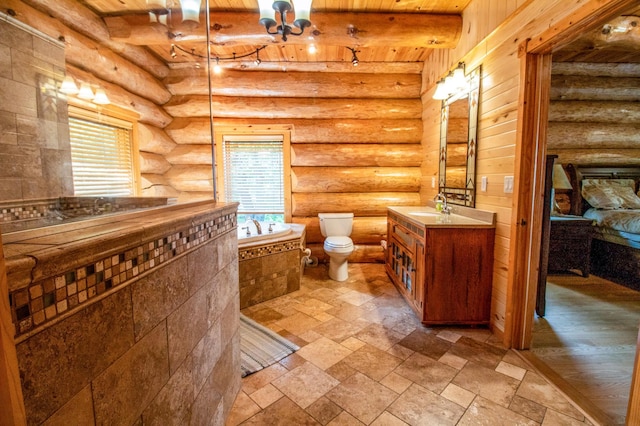 bathroom with toilet, rustic walls, beam ceiling, a washtub, and vanity