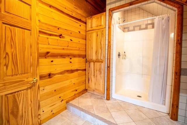 bathroom with walk in shower, tile patterned flooring, and wooden walls