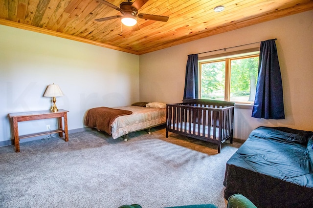 carpeted bedroom featuring ceiling fan, wood ceiling, and crown molding