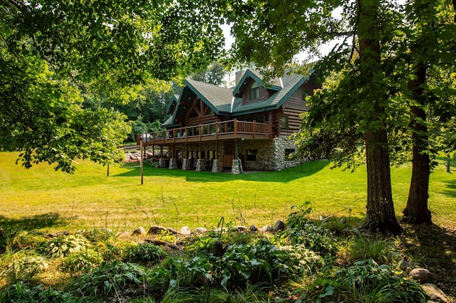 rear view of property with a deck and a lawn