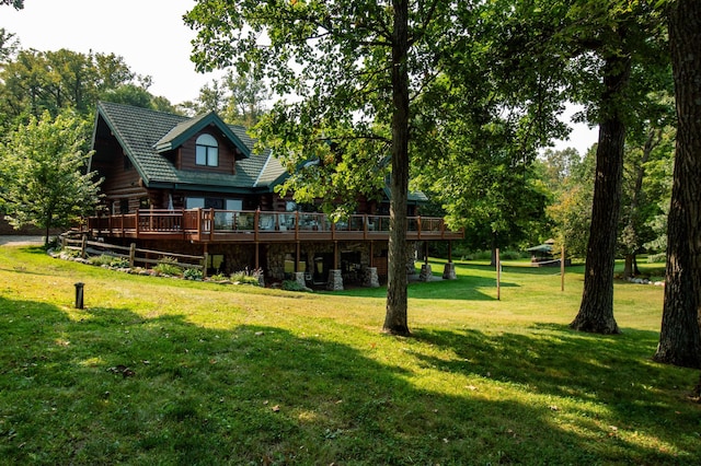 rear view of property with a deck and a yard