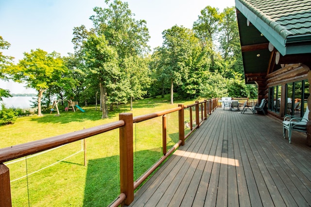 wooden terrace with a yard and a playground