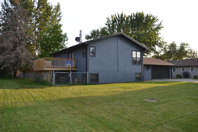 view of property exterior featuring a deck, a yard, and a garage