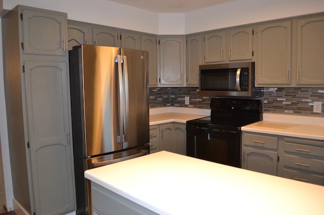 kitchen with appliances with stainless steel finishes and tasteful backsplash