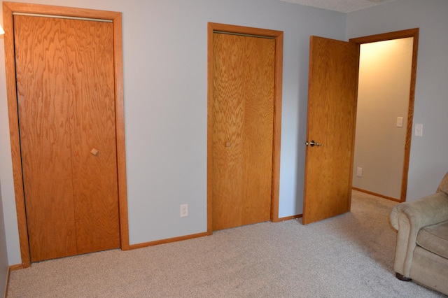 unfurnished room featuring light carpet