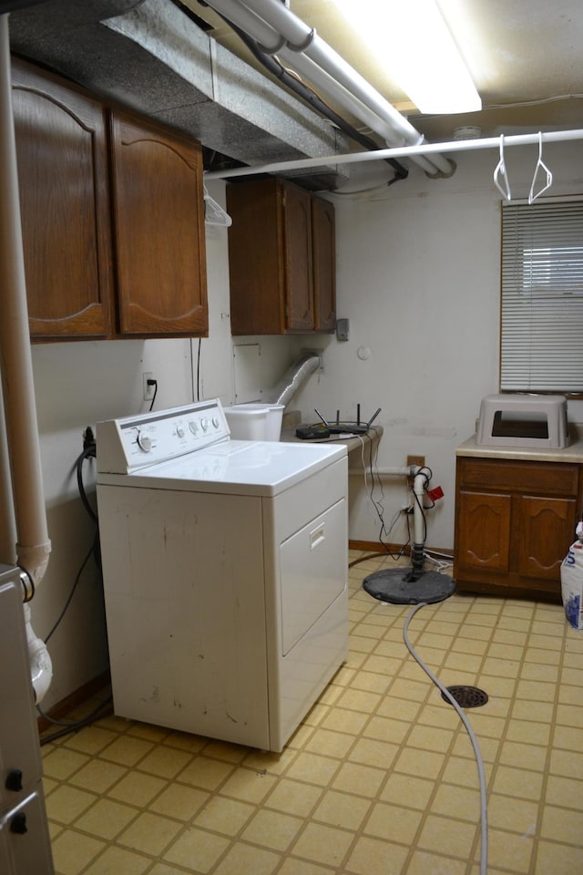 washroom featuring washer / dryer and cabinets