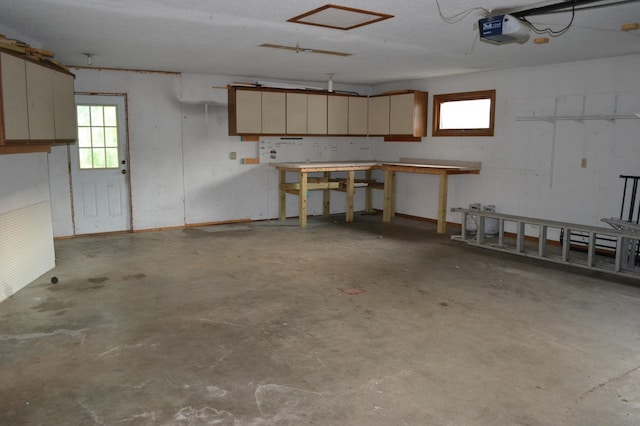 garage with a workshop area and a garage door opener