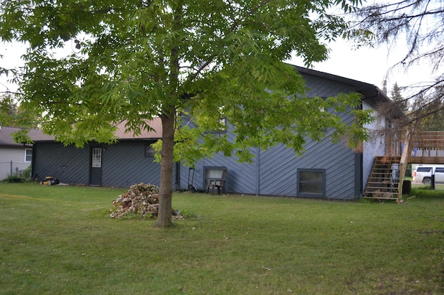 view of side of home with a lawn